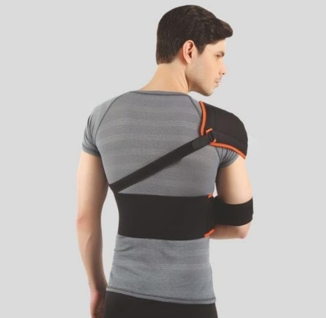 Man wearing a black shoulder brace on a gray background
