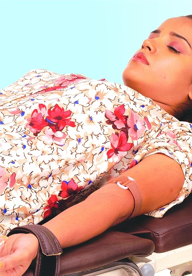 Person receiving a massage with a floral-patterned cover over their body